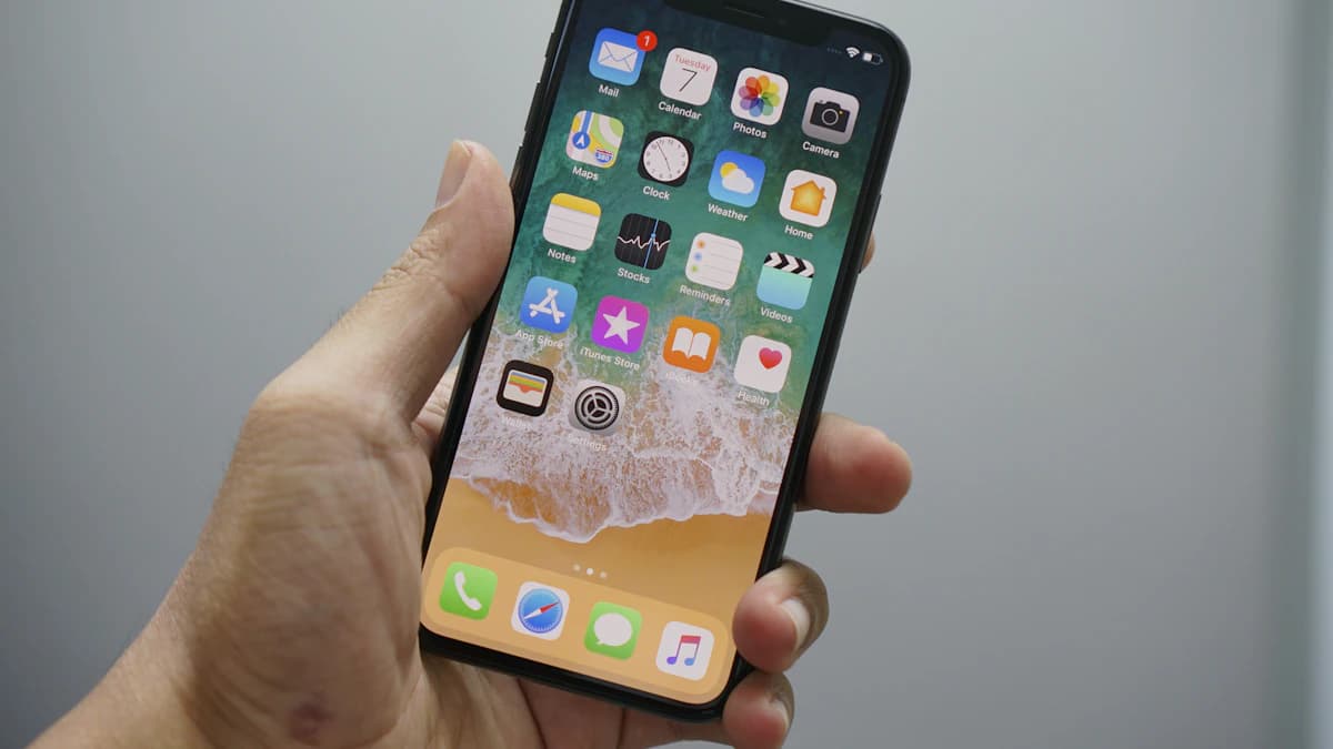 Dłoń trzymająca telefon z zaznaczonym zasięgiem kciuka na ekranie